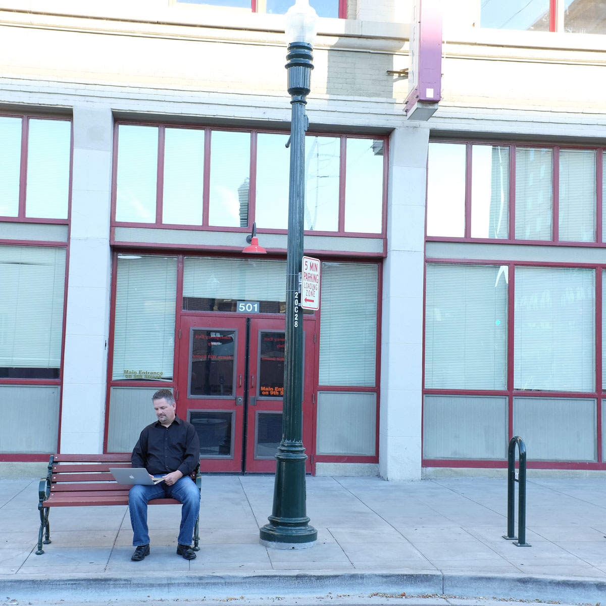 Talloo creator George Seybold working on a bench downtown