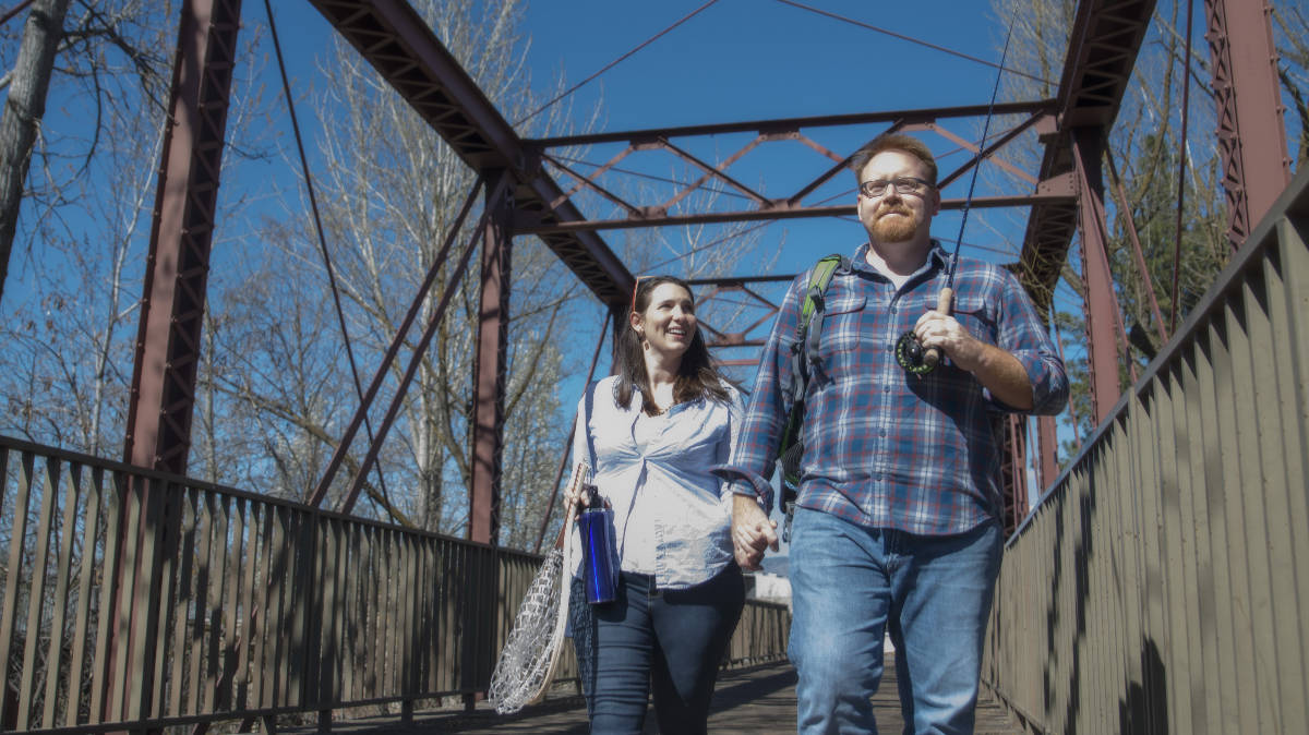 Lone Cone creators Annalisa and Ken crossing bridge in Boise